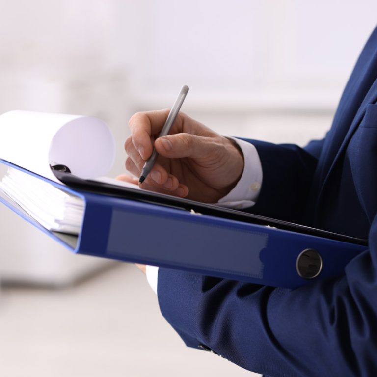 Real estate appraisal. Inspector with clipboard conducting property valuation indoors, closeup