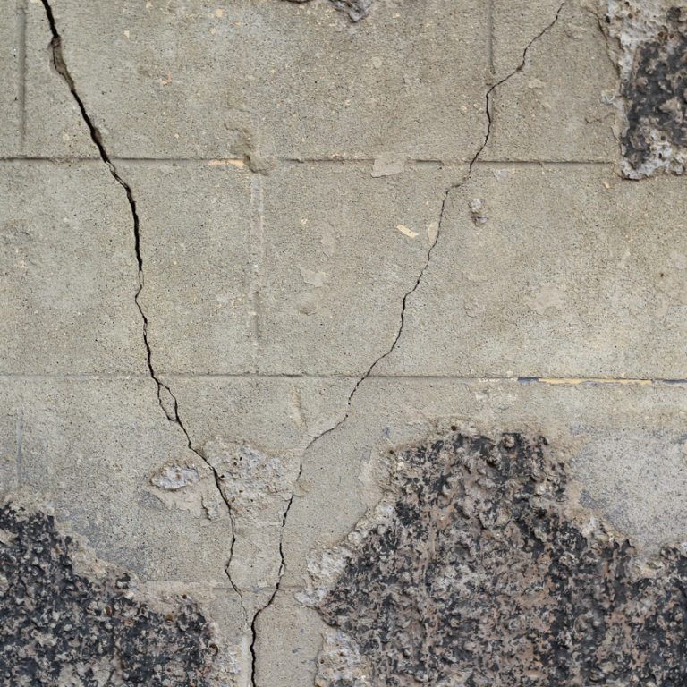 Large crack in the wall of the house, background